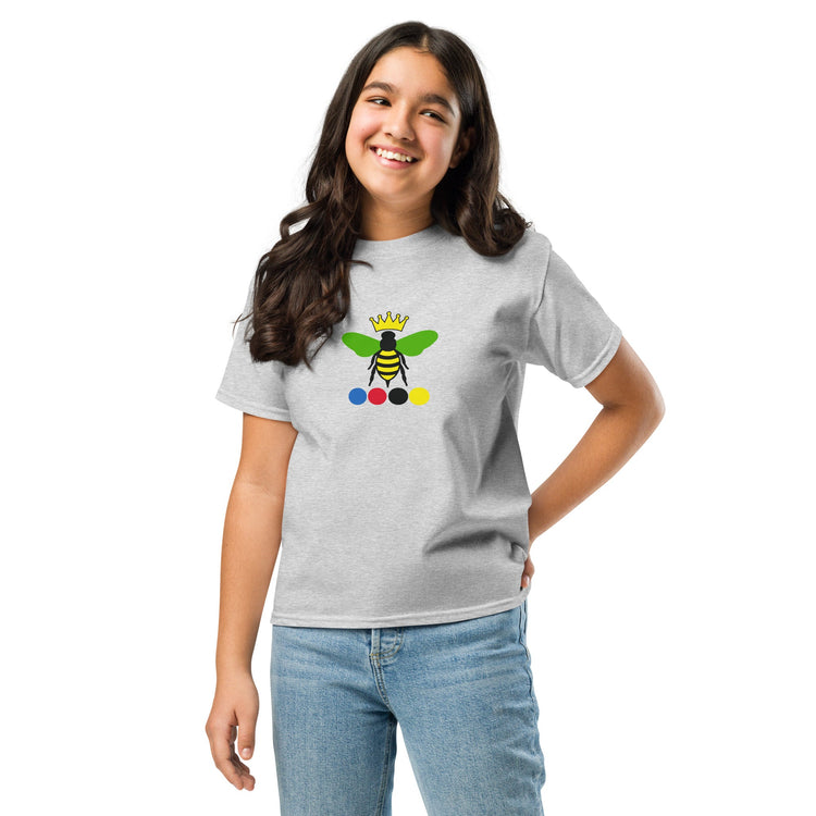 A young girl with posing in a light gray heather t-shirt with a colorful queen bee of croquet graphic.