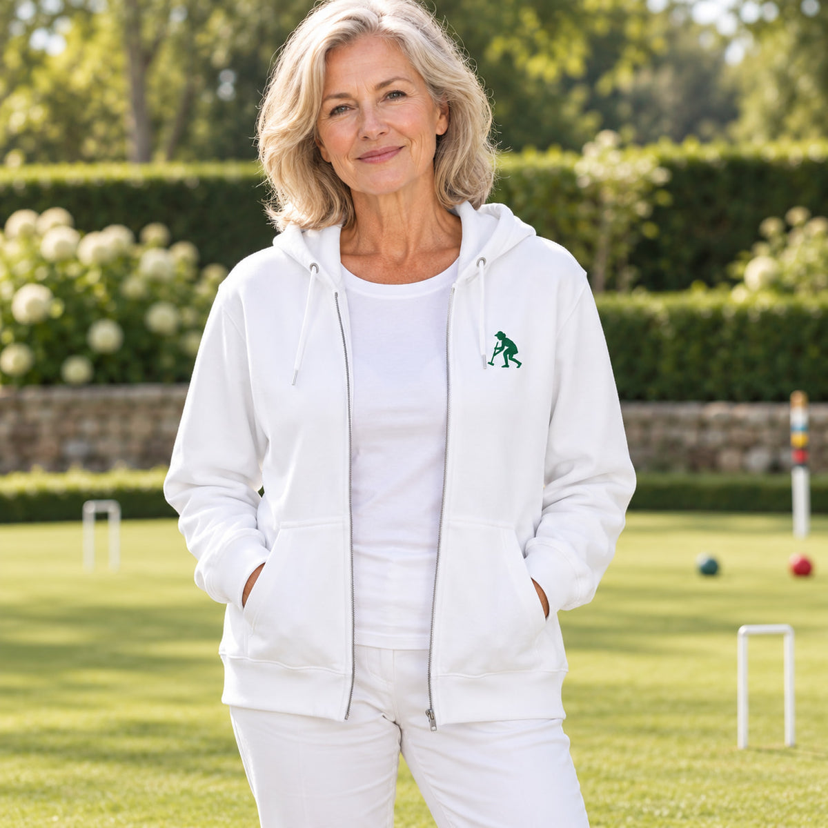 A woman wearing a white zip-up hoodie with a sLady Striker embroidered logo on the left chest.