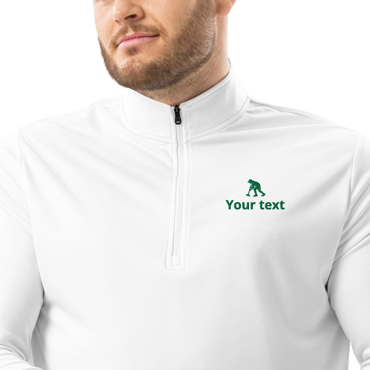 A close-up of a man wearing a white long-sleeve quarter-zip pullover withcroquet striker logo.