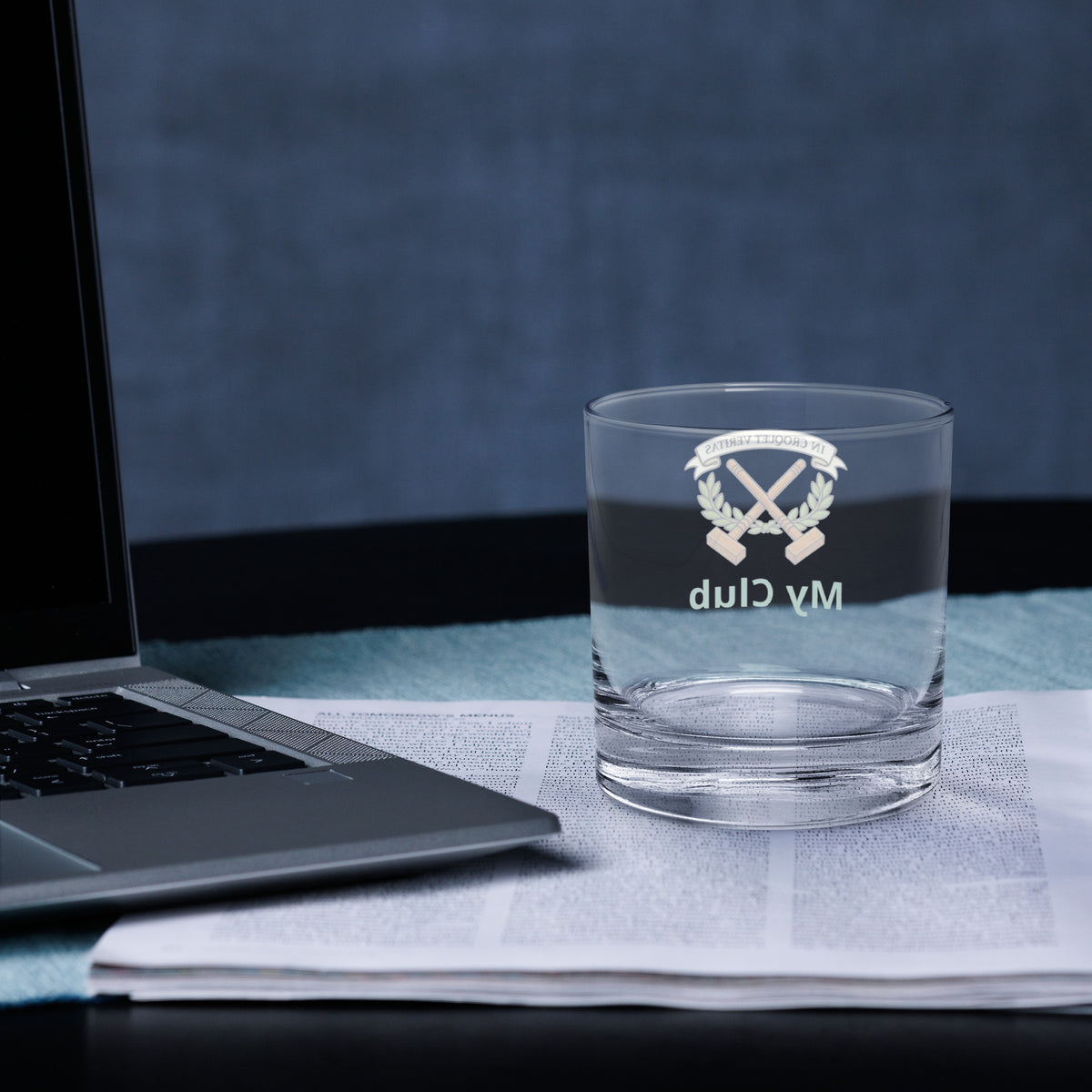 rocks glass with a croquet logo