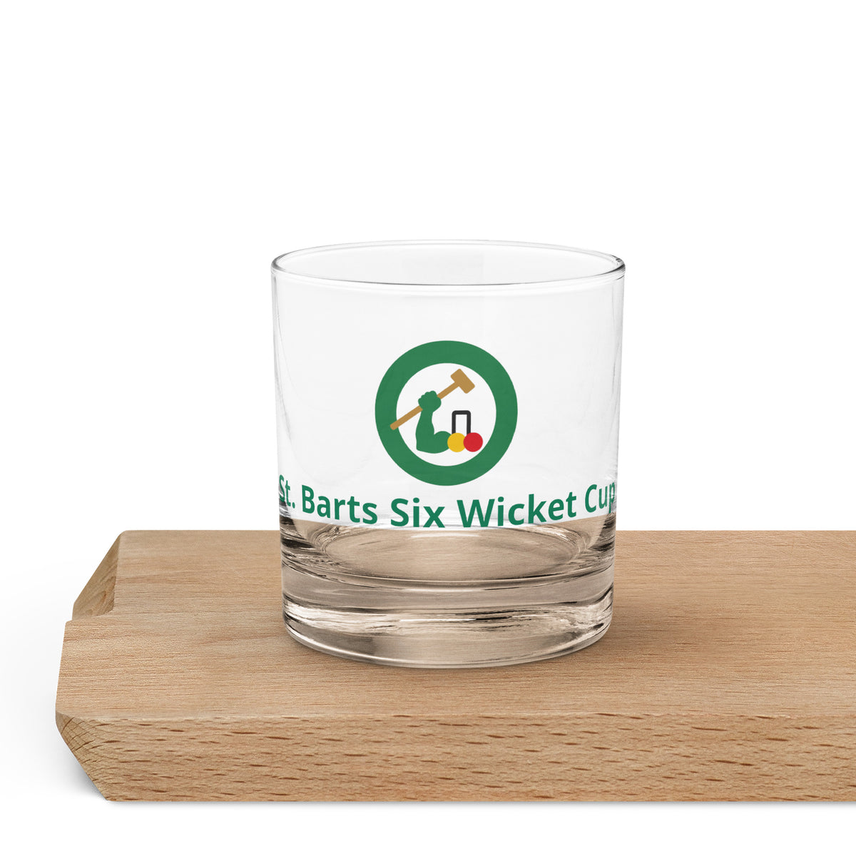 a rocks whiskey glass with the logo of an arm swinging a  croquet mallet