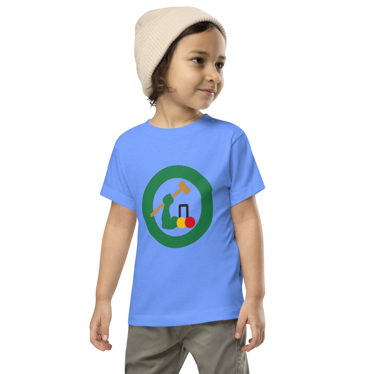 A toddler wearing a light blue t-shirt with a circular croquet mallet graphic